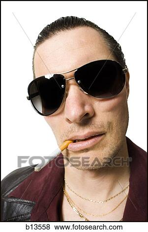 Man in sunglasses smoking cigarette View Large Photo Image Stock Photo - Man in sunglasses smoking cigarette. Fotosearch