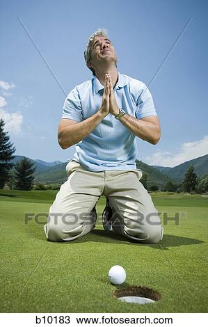Man kneeling near a golf hole and praying View Large Photo Image Stock Image - Man kneeling near a golf hole and praying. Fotosearch
