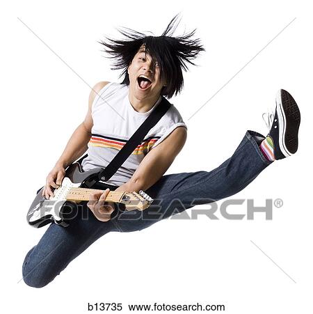 Stock Photography - Man leaping with electric guitar smiling. Fotosearch