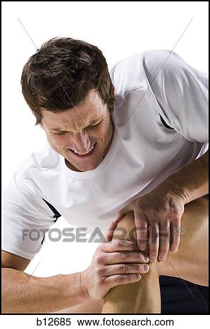 Man massaging a sore knee View Large Photo Image Stock Photography - Man massaging a sore knee. Fotosearch