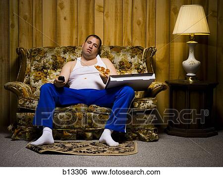 Man on sofa with pizza and TV remote View Large Photo Image Stock Photograph - Man on sofa with pizza and TV remote. Fotosearch