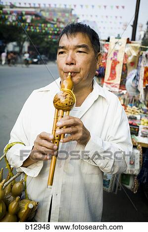 Man playing a Chinese woodwind instrument View Large Photo Image Stock Photo - Man playing a Chinese woodwind instrument. Fotosearch