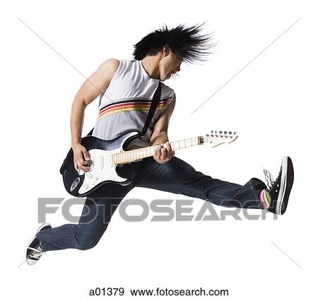 Man playing electric guitar and jumping View Large Photo Image Stock Photo - Man playing electric guitar and jumping. Fotosearch