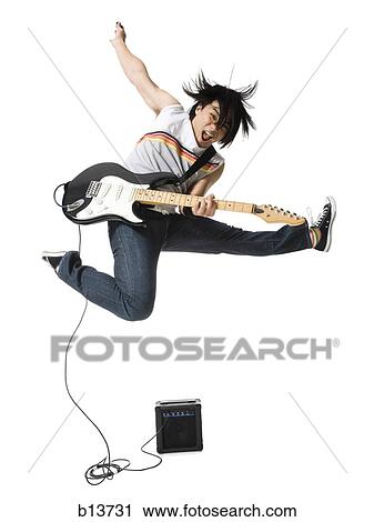 Man playing electric guitar with amp leaping View Large Photo Image Stock Image - Man playing electric guitar with amp leaping. Fotosearch