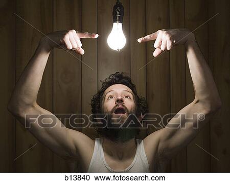 Man pointing at light bulb View Large Photo Image Stock Image - Man pointing at light bulb. Fotosearch
