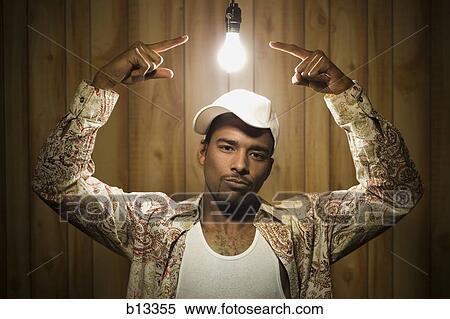 Stock Photography - Man pointing at light bulb. Fotosearch