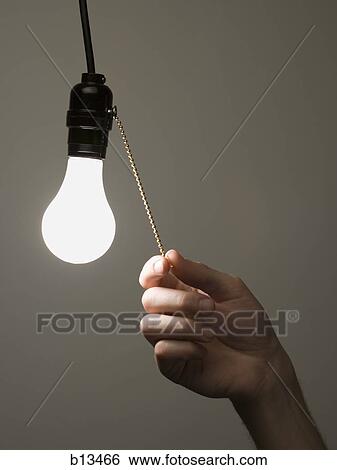 Stock Photograph - Man pulling light switch. Fotosearch
