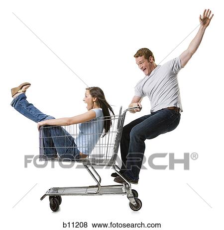 Man pushing shopping cart with girlfriend inside View Large Photo Image Stock Photo - Man pushing shopping cart with girlfriend inside. Fotosearch
