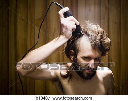 Man shaving head with electric razor View Large Photo Image Stock Photo - Man shaving head with electric razor. Fotosearch