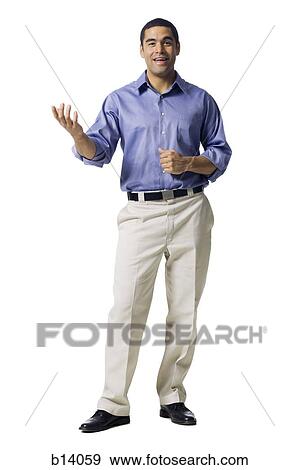 Stock Photo - Man standing and gesturing with hands smiling. Fotosearch
