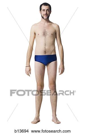 Picture - Man standing in swimsuit smiling. Fotosearch