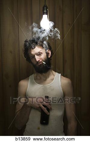 Man standing under light bulb with cigarette and beer bottle View Large Photo Image Stock Photo - Man standing under light bulb with cigarette and beer bottle. Fotosearch