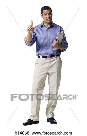 Stock Photo - Man standing with clipboard pointing. Fotosearch