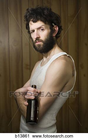 Man standing with crossed arms and beer bottle View Large Photo Image Stock Image - Man standing with crossed arms and beer bottle. Fotosearch