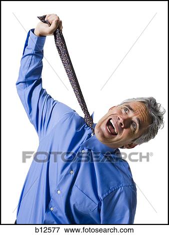 Man strangling himself with necktie View Large Photo Image Stock Photo - Man strangling himself with necktie. Fotosearch