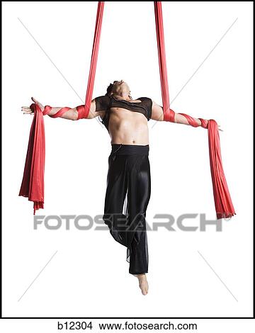 Picture - Man tangled in red drapes. Fotosearch