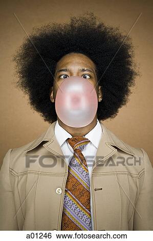 Man with an afro in beige suit blowing a bubble View Large Photo Image Stock Photograph - Man with an afro in beige suit blowing a bubble. Fotosearch