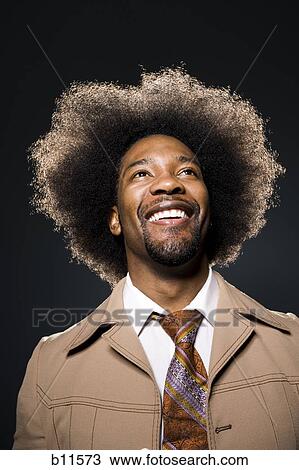 Man with an afro in beige suit View Large Photo Image Stock Image - Man with an afro in beige suit. Fotosearch