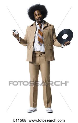 Man with an afro in beige suit listening to MP3 player View Large Photo Image Stock Photo - Man with an afro in beige suit listening to MP3 player. Fotosearch