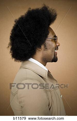 Stock Photo - Man with an afro in beige suit. Fotosearch