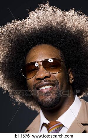 Stock Photograph - Man with an afro in beige suit. Fotosearch