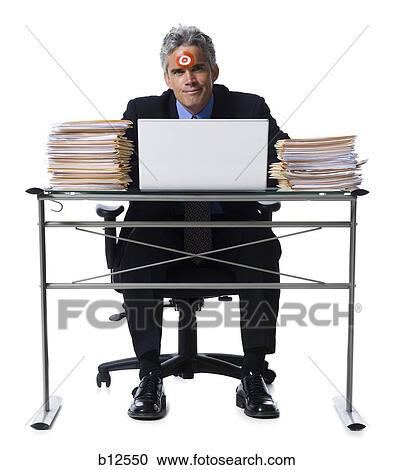 Man with bull's-eye on forehead working on laptop View Large Photo Image Stock Image - Man with bull's-eye on forehead working on laptop. Fotosearch