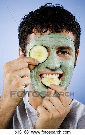 Man with facial mask and cucumber slices View Large Photo Image Stock Photo - Man with facial mask and cucumber slices. Fotosearch