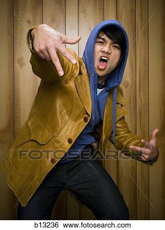Man with hoodie and leather jacket posing View Large Photo Image Stock Photograph - Man with hoodie and leather jacket posing. Fotosearch