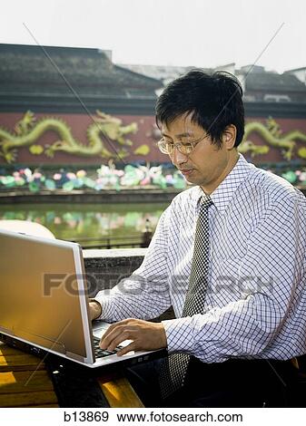Man with laptop in business attire outdoors View Large Photo Image Stock Photo - Man with laptop in business attire outdoors. Fotosearch