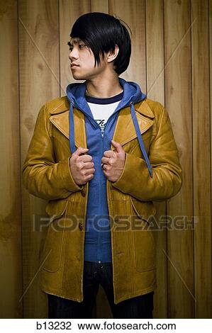 Man with leather jacket and hoodie posing side profile View Large Photo Image Stock Image - Man with leather jacket and hoodie posing side profile. Fotosearch