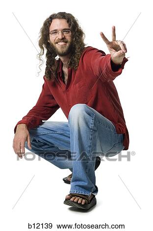 Man with long hair and beard making peace gesture View Large Photo Image Stock Photo - Man with long hair and beard making peace gesture. Fotosearch