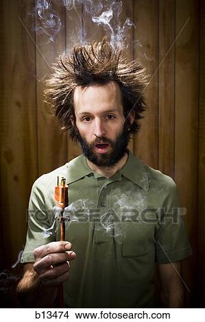 Man with smoking hair and electrical plug View Large Photo Image Picture - Man with smoking hair and electrical plug. Fotosearch