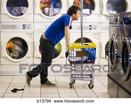 Man with trolley at Laundromat View Large Photo Image Picture - Man with trolley at Laundromat. Fotosearch