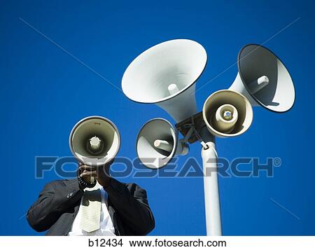 Picture - Man yelling through bullhorn. Fotosearch