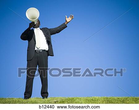 Man yelling through bullhorn View Large Photo Image Stock Image - Man yelling through bullhorn. Fotosearch