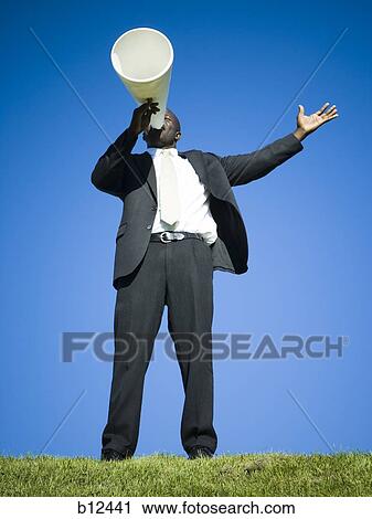 Stock Image - Man yelling through bullhorn. Fotosearch