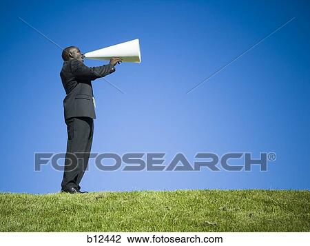 Man yelling through bullhorn View Large Photo Image Stock Image - Man yelling through bullhorn. Fotosearch