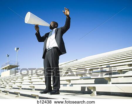 Man yelling through bullhorn View Large Photo Image Stock Photo - Man yelling through bullhorn. Fotosearch