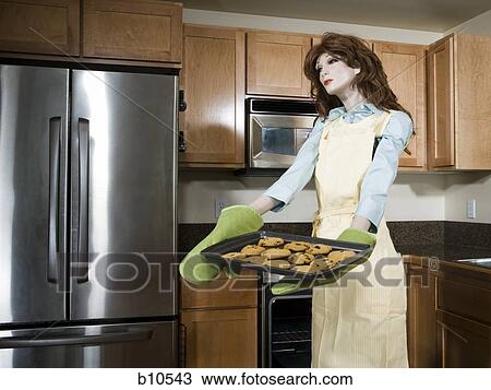 Mannequin portraying a woman holding a tray of biscuits View Large Photo Image Stock Image - Mannequin portraying a woman holding a tray of biscuits. Fotosearch