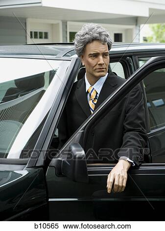 Stock Photography - Mannequin standing beside a car. Fotosearch
