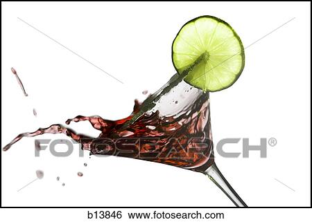 Stock Photograph - Martini with lime garnish spilling. Fotosearch