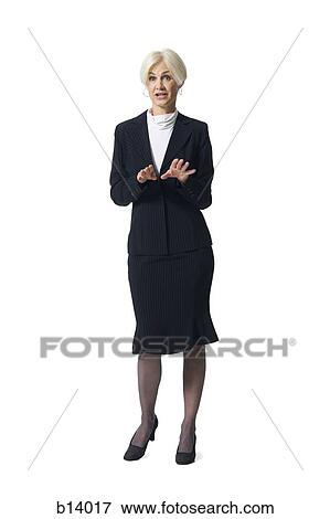 Stock Photo - Mature businesswoman standing and gesturing with hands. Fotosearch