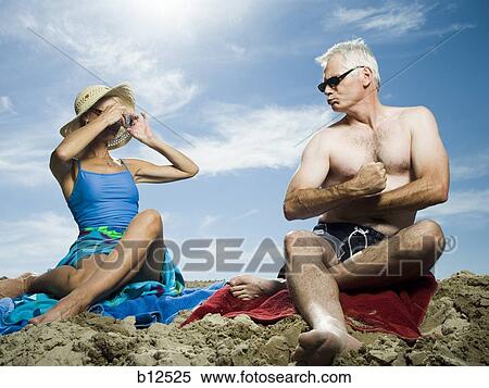 Mature couple relaxing at the beach View Large Photo Image Stock Photography - Mature couple relaxing at the beach. Fotosearch