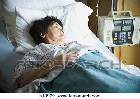 Stock Photo - Mature woman in hospital bed. Fotosearch