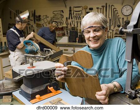 Mature woman in wood shop smiling View Large Photo Image Stock Photo - Mature woman in wood shop smiling. Fotosearch