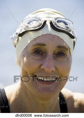 Mature woman with swimming cap and goggles smiling View Large Photo Image Stock Photograph - Mature woman with swimming cap and goggles smiling. Fotosearch