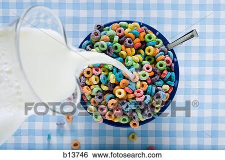 Milk pouring from jug into cereal bowl View Large Photo Image Stock Photograph - Milk pouring from jug into cereal bowl. Fotosearch