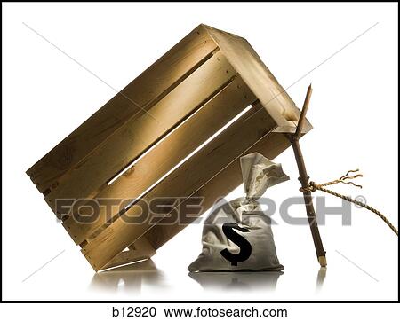 Money bag placed under wooden crate trap View Large Photo Image Stock Image - Money bag placed under wooden crate trap. Fotosearch