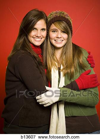 Mother and daughter embracing with hats and scarves View Large Photo Image Stock Photo - Mother and daughter embracing with hats and scarves. Fotosearch