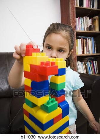 Stock Image - Mother and young daughter playing with building blocks. Fotosearch